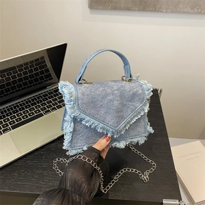 Light blue denim mini handbag with fringe tassels and silver chain strap for women