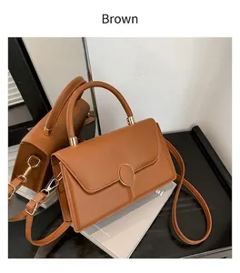 Brown leather crossbody bag with gold ring buckle and adjustable shoulder strap