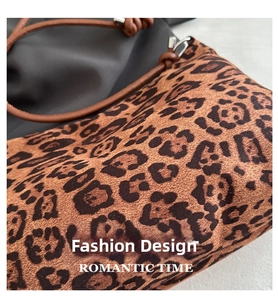 Detailed view of leopard print texture and spliced dark gray fabric with cord strap
