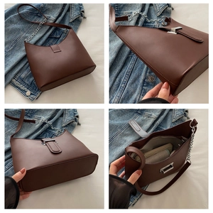 Detail view of coffee brown crescent bag with chain strap and interior storage