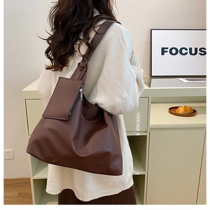 Brown soft leather tote bag with matching square pouch and stylish knot detail