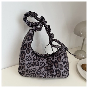 Detail of leopard print crescent bag with stylish ruched drawstring shoulder strap