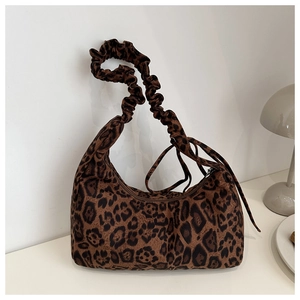 Detail of the leopard print hobo bag showing the plush texture and ruched strap design