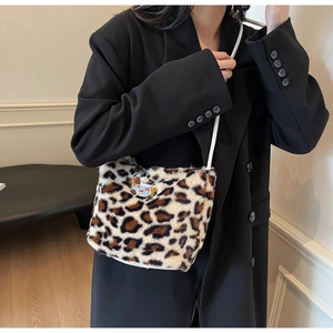Leopard print plush shoulder bag with cute bear patch, styled on a black blazer