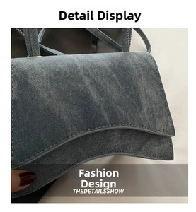 Close-up of dark denim fabric texture and curved stitching on retro small square bag