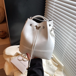 Chic white bucket backpack with silver butterfly detail and drawstring closure