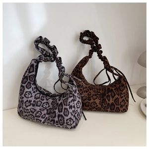 Detail of leopard print crescent bags with pleated handles in grey and tan finishes