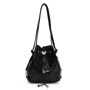 Fashionable black drawstring bucket bag with a silver butterfly charm on a white background