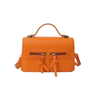 Vibrant orange crossbody bag with double zip design and smooth faux leather finish