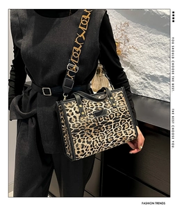 Detail of leopard print tote bag with wide patterned shoulder strap and leather trim
