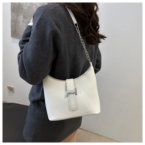 Model view of white crescent shoulder bag with silver hardware and chain strap detail