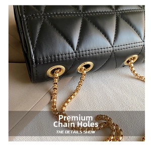Close-up of black quilted leather with elegant gold metal chain and eyelets detail