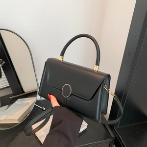 Classic black matte leather crossbody bag with round gold buckle and elegant top handle