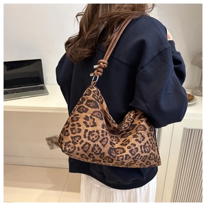 Detail of hobo shoulder bag featuring leopard print and knotted leather strap details