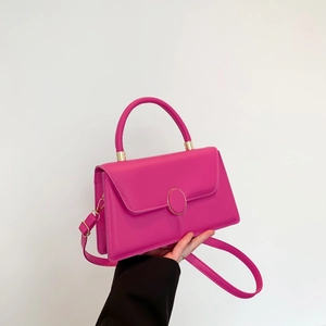 Fashionable bright pink textured crossbody square bag with gold buckle and top handle