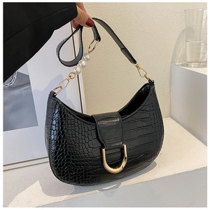 Detail of black croc-effect half-moon bag featuring large pearl strap and gold hardware