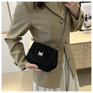 Fashionable black pleated saddle bag with silver butterfly buckle and chain strap
