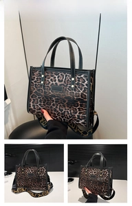 Close-up of leopard print tote bag with black leather trim and wide patterned shoulder strap