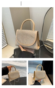 Detail view of khaki rhinestone handbag with metal chain strap and top handle