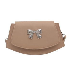 Elegant beige crossbody bag featuring a large silver metal bow accent and leather texture