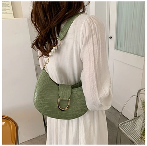 Detailed view of crocodile texture hobo bag with large faux pearls and golden U-buckle