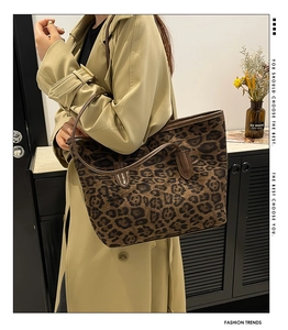 Close-up of stylish leopard print tote bag styled with a modern trench coat for work