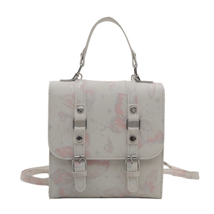 Mini cream backpack with butterfly patterns, silver buckles and top handle on white base