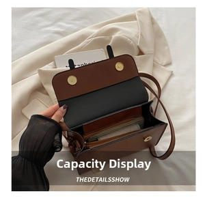 Detailed view of the brown leather bag's interior showing multiple storage compartments