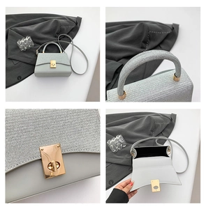 Detail view of the metallic finish contrast and gold hardware on the grey square handbag