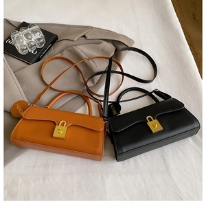 Detailed view of vintage leather crossbody bags with golden locks in brown and black