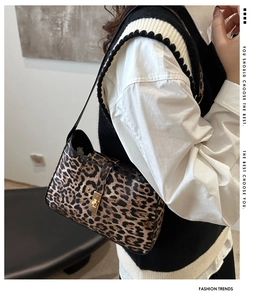 Leopard print shoulder bag with gold buckle closure worn by model for daily outfit