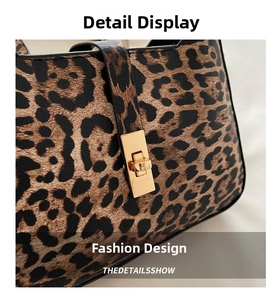 Detailed macro view of leopard print handbag with golden rectangular metal twist lock