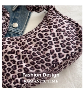 Detail of vintage leopard print crossbody bag with velvet texture and drawstring closure