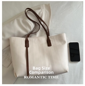 Detail of off-white wavy texture tote bag compared with a smartphone for size display
