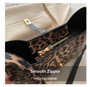 Close-up of leopard print shoulder bag featuring smooth gold zipper and black strap