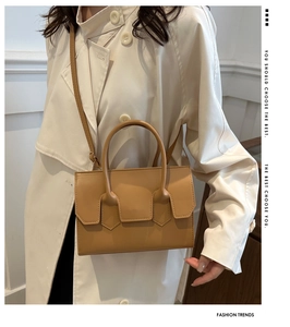 Khaki crossbody bag worn over a beige trench coat for a minimalist daily outfit