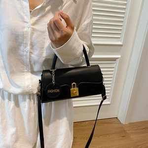 Chic black crossbody rectangular bag with gold twist lock and adjustable shoulder strap