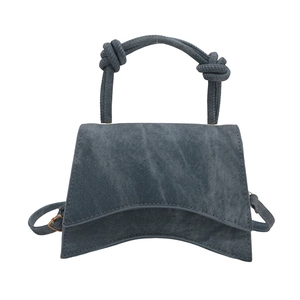 Denim trapezoid handbag with crescent base and knot handles in washed blue-grey