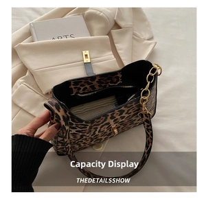 Close-up of leopard print shoulder bag interior showing large capacity and zipper pocket