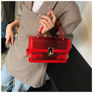 Detail of red crocodile pattern PU handbag featuring gold metal buckle and vintage style