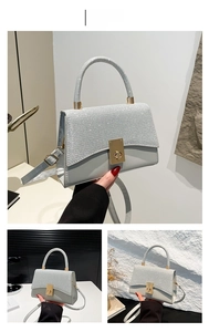 Close-up of sparkling silver rhinestone handbag with golden lock and sequins detail