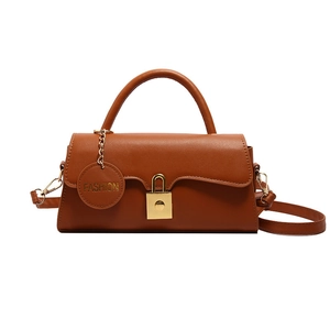 Vintage brown PU leather crossbody bag with gold metal clasp and top handle on white background