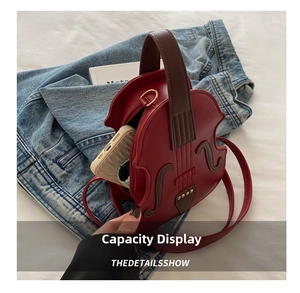 Detail show of violin-shaped red leather handbag with interior storage for phone