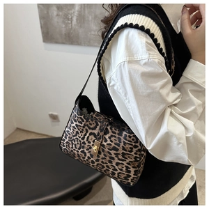 Détail du sac bandoulière léopard avec un fermoir rotatif en métal doré élégant