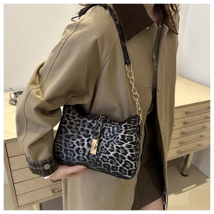Leopard print crossbody bag with gold chain strap and metal twist lock detail