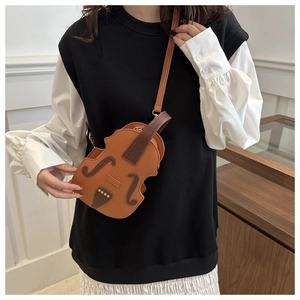 Detail view of violin shaped crossbody bag featuring adjustable strap and retro stitching