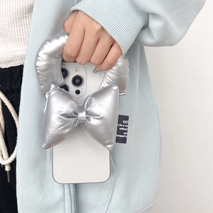 Puffy silver metallic bow phone strap with adjustable handle on soft leather case