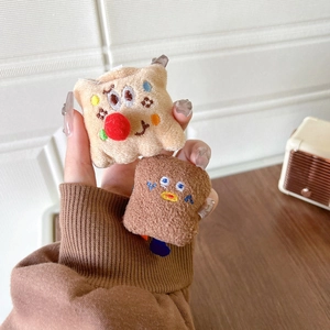 Cute plush cookie phone stand and grip featuring embroidery and colorful pom-poms