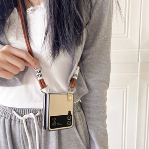 Crossbody phone case for Samsung Z Flip 6 with brown fabric strap and cream shell