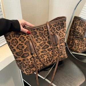 Large leopard print tote bag with plush fabric and brown leather handles for women